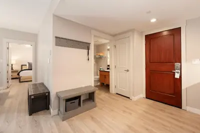 a living room with a tv and a door at Founders Pointe 4355 Ski In Ski Out Winter Park Resort in Winter Park
