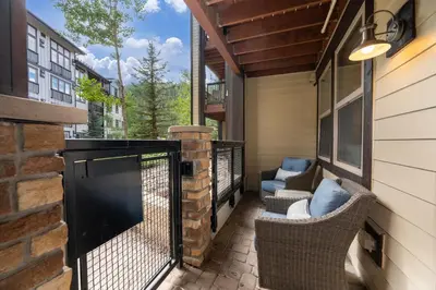 a balcony with wicker chairs and a fireplace on a house at Founders Pointe 4355 Ski In Ski Out Winter Park Resort in Winter Park