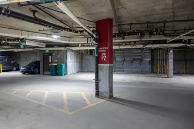an empty parking garage with a red sign in it at Founders Pointe 4355 Ski In Ski Out Winter Park Resort in Winter Park