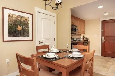 a dining room with a wooden table and chairs at Founders Pointe 4473 Ski In Ski Out Winter Park Resort in Winter Park