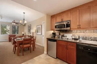 a kitchen and dining room with a table and chairs at Founders Pointe 4473 Ski In Ski Out Winter Park Resort in Winter Park