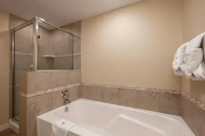 a white tub in a bathroom with a shower at Founders Pointe 4473 Ski In Ski Out Winter Park Resort in Winter Park