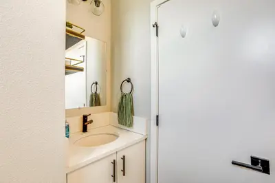 a bathroom with a sink and a mirror at 2 Mi to Ball Arena Townhome with Rooftop Patio in Denver