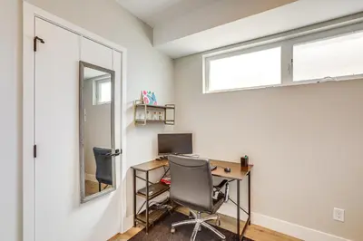 a home office with a desk and a window at 2 Mi to Ball Arena Townhome with Rooftop Patio in Denver