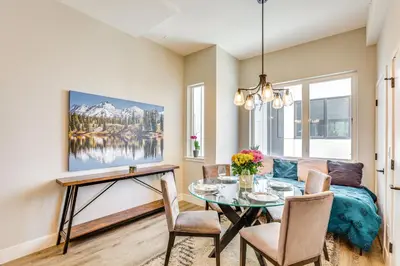 a dining room with a table and a couch at 2 Mi to Ball Arena Townhome with Rooftop Patio in Denver