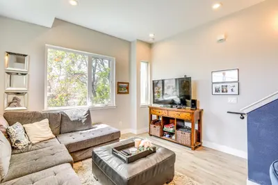 a living room with a couch and a tv at 2 Mi to Ball Arena Townhome with Rooftop Patio in Denver