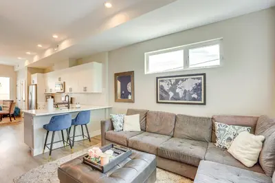 a living room with a couch and a kitchen at 2 Mi to Ball Arena Townhome with Rooftop Patio in Denver