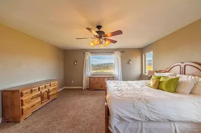 a bedroom with a bed and a ceiling fan at Mountain Retreat Near Grand Lake in Grand Lake