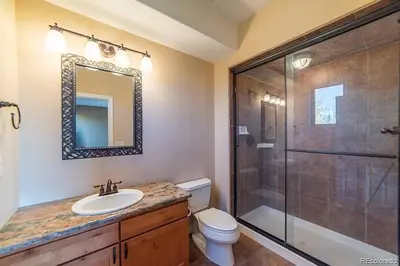 a bathroom with a toilet and a shower and a sink at Mountain Retreat Near Grand Lake in Grand Lake