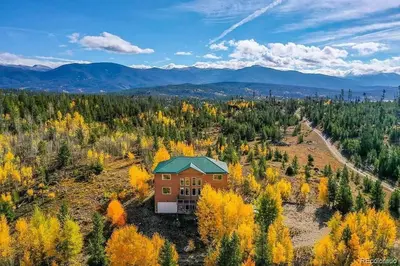 an aerial view of a house in the middle of a forest at Mountain Retreat Near Grand Lake in Grand Lake