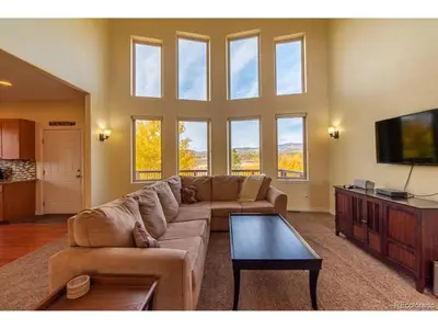 a living room with a couch and a flat screen tv at Mountain Retreat Near Grand Lake in Grand Lake
