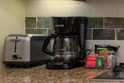 a coffee maker sitting on a counter next to a microwave at Fraser Crossing 3227 Ski In Ski Out Winter Park Resort in Winter Park