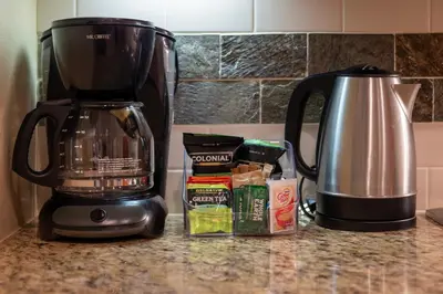 a kitchen counter with a coffee maker and coffee ingredients at Fraser Crossing 3423 Ski In Ski Out Winter Park Resort in Winter Park