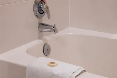a white bathroom with a toilet and a sink at Fraser Crossing 3423 Ski In Ski Out Winter Park Resort in Winter Park