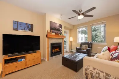 a living room with a flat screen tv and a fireplace at Fraser Crossing 3423 Ski In Ski Out Winter Park Resort in Winter Park