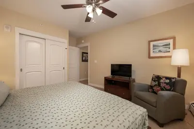 a bedroom with a bed and a chair and a ceiling fan at Fraser Crossing 3405 Ski In Ski Out Winter Park Resort in Winter Park