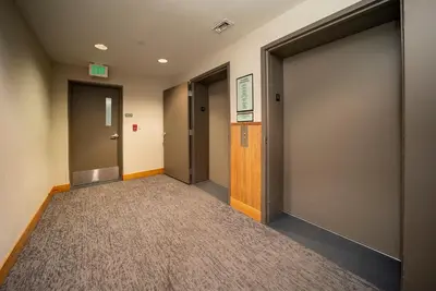 a hallway with two elevators and a door at Fraser Crossing 3405 Ski In Ski Out Winter Park Resort in Winter Park