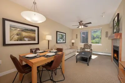 a living room with a table and a couch at Fraser Crossing 3405 Ski In Ski Out Winter Park Resort in Winter Park