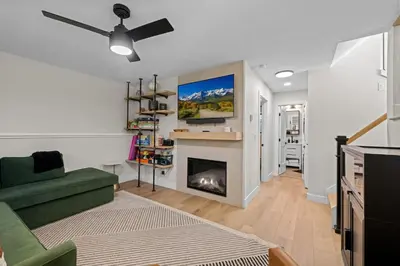 a living room with a fireplace and a green couch at 249 E Coyote in Silverthorne
