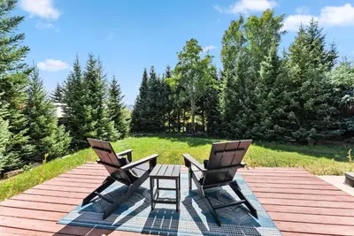 two chairs and a table on a wooden deck at 249 E Coyote in Silverthorne