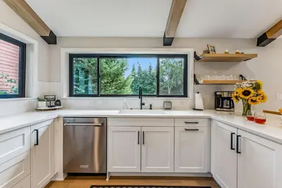 a kitchen with white cabinets and a window at 249 E Coyote in Silverthorne