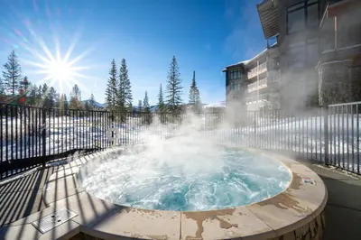 a hot tub with a fountain in front of a building at Timber Fox 3309 Downtown Condo - Beautiful Fireplace in Winter Park