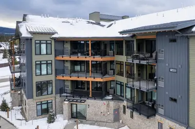 an apartment building with snow on the roof at Timber Fox 3309 Downtown Condo - Beautiful Fireplace in Winter Park