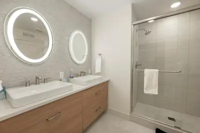 a bathroom with a sink and a mirror and a shower at Timber Fox 3309 Downtown Condo - Beautiful Fireplace in Winter Park