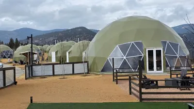 a group of domes with mountains in the background at The Nest at Black Hawk in Black Hawk