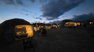 a group of tents in a field at night at The Nest at Black Hawk in Black Hawk