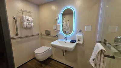 a bathroom with a sink and a toilet and a mirror at The Nest at Black Hawk in Black Hawk