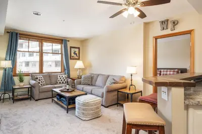 a living room with a couch and a table at Zephyr Mountain Lodge 1420 Ski-In Ski-out Winter Park Resort base in Winter Park