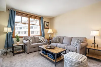 a living room with a couch and a table at Zephyr Mountain Lodge 1420 Ski-In Ski-out Winter Park Resort base in Winter Park