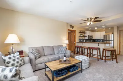 a living room with a couch and a table at Zephyr Mountain Lodge 1420 Ski-In Ski-out Winter Park Resort base in Winter Park