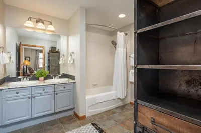 a bathroom with two sinks and a shower and a tub at Zephyr Mountain Lodge 1420 Ski-In Ski-out Winter Park Resort base in Winter Park