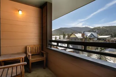 a balcony with a bench and a view of the mountains at Zephyr Mountain Lodge 1420 Ski-In Ski-out Winter Park Resort base in Winter Park