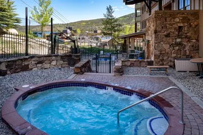 a hot tub in the middle of a yard at Zephyr Mountain Lodge 1420 Ski-In Ski-out Winter Park Resort base in Winter Park