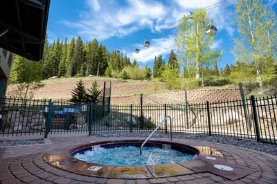 a hot tub with a ski lift in the sky at Zephyr Mountain Lodge 1420 Ski-In Ski-out Winter Park Resort base in Winter Park