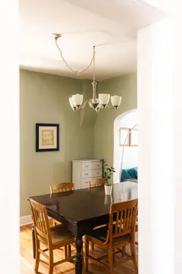 a dining room with a black table and chairs at Charming Highlands Cottage - Walk to Shops & Eats in Denver