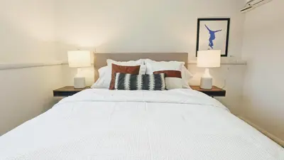 a bedroom with a large white bed with two lamps at Cozy Monthly 1BR Near NREL & Trails - Quaker Room 1 in Golden