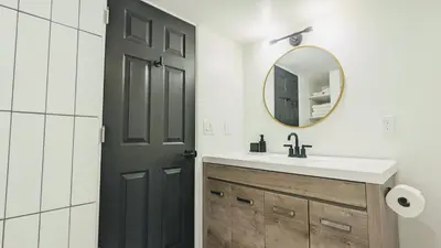 a bathroom with a sink and a black door at Cozy Monthly 1BR Near NREL & Trails - Quaker Room 1 in Golden