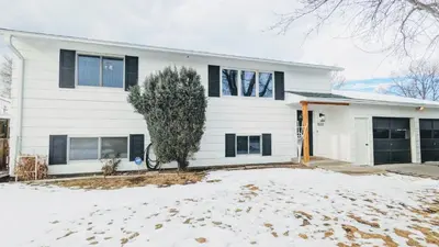 a white house with a tree in the snow at Cozy Monthly 1BR Near NREL & Trails - Quaker Room 1 in Golden