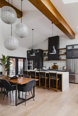 a kitchen with a wooden table and chairs at Midtown Oasis in Fort Collins
