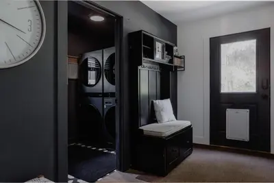 a room with two washer and dryers and a clock at Midtown Oasis in Fort Collins