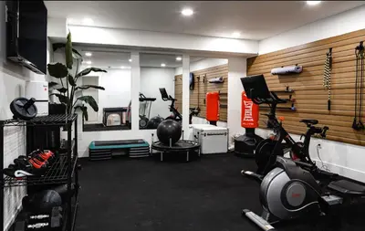 a gym with several exercise equipment in a room at Midtown Oasis in Fort Collins