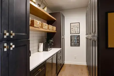 a kitchen with black cabinets and a microwave at Midtown Oasis in Fort Collins