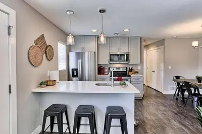 a kitchen with a counter and some stools in it at Quiet and Comfy Oasis - Firepit and Yard in Denver in Denver