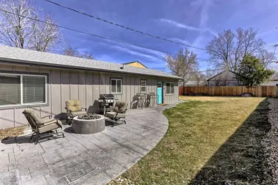 a patio with chairs and a grill in front of a house at Quiet and Comfy Oasis - Firepit and Yard in Denver in Denver