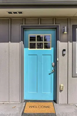 a blue door on the side of a building at Quiet and Comfy Oasis - Firepit and Yard in Denver in Denver