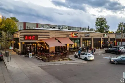 a store in a parking lot with cars in front of it at Spacious and Quiet Retreat - Firepit and Yard in Denver